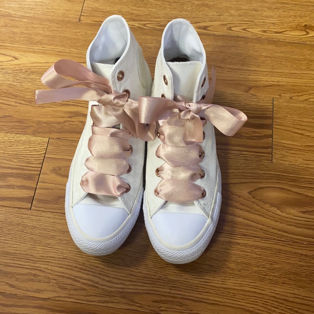 Woman’s fashion sneakers. Cream ribbon converse